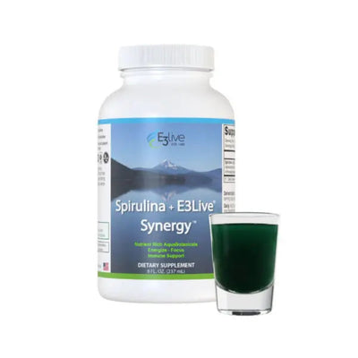 white container with blue and white label with E3Live logo, Spirulina + E3Live Synergy, nutrient rich AquaBotanicals, energize, focus, immune support, dietary supplement 8oz, background image of mountains and lake reflection, and shot glass of green drink