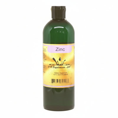 Green bottle of zinc supplement with a label on a white background