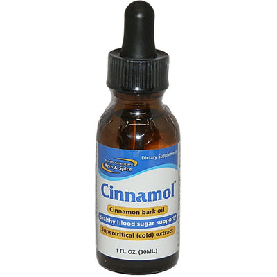 dark brown dropper bottle of Cinnamol cinnamon bark oil on a white background