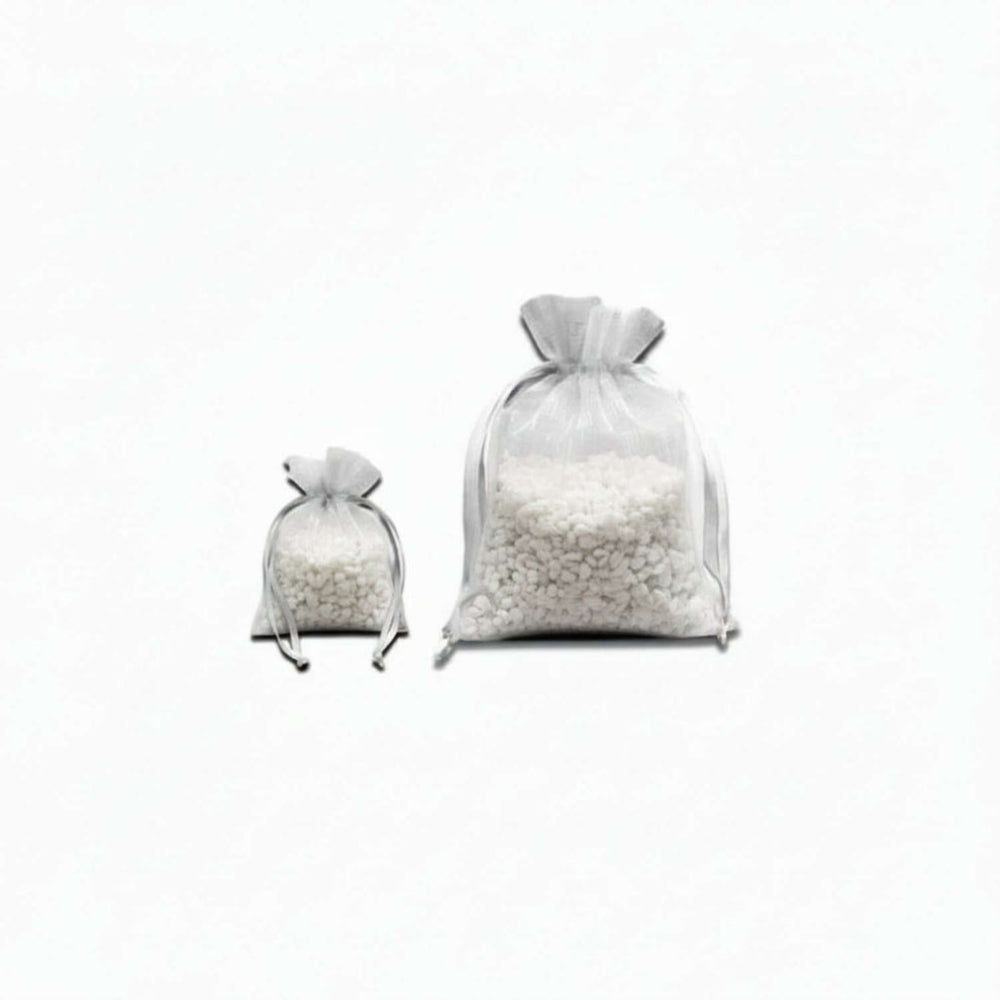 Two clear bags filled with white beads on a white background