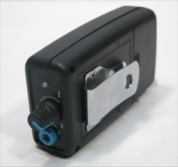 Black and silver device with a dial on a white background