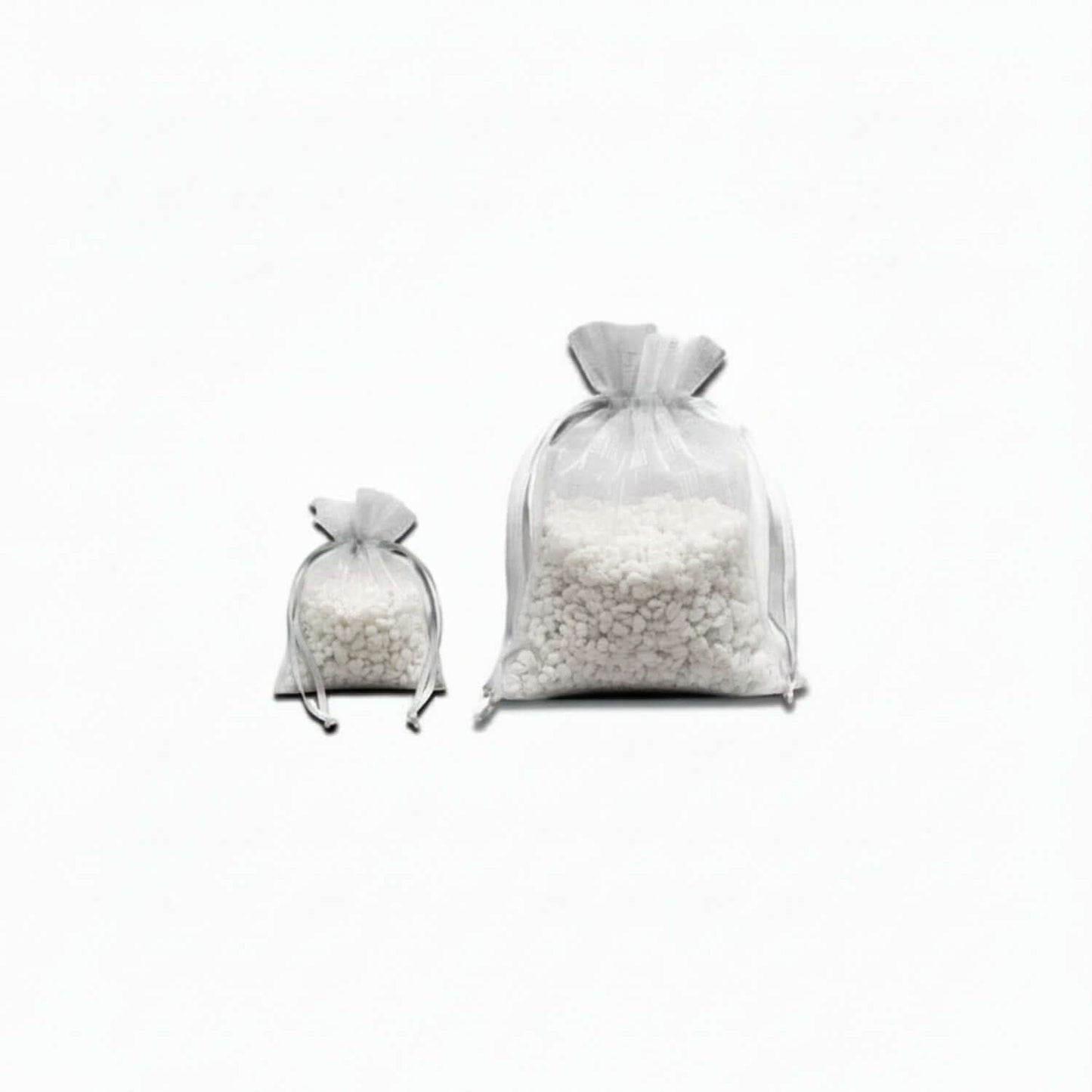 Two white satchels full of small white 'rocks' on a white background