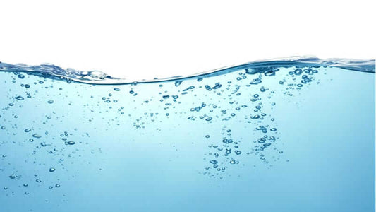 Close-up image of bubbles and surface of liquid water illustrating the Structure of Liquid Water.