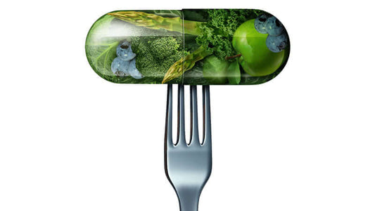 Image of a fork holding a capsule filled with vegetables, illustrating Synthetic vs Natural Supplements.