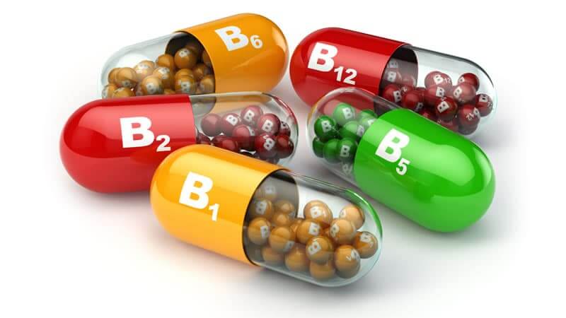Vitamin B Explained: colorful capsules labeled B1, B2, B5, B6, and B12 showcasing various B vitamins.