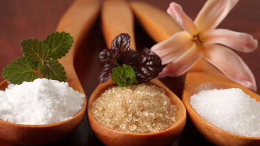 Iodine Dosage image featuring different types of salts and herbs in wooden spoons with a flower.