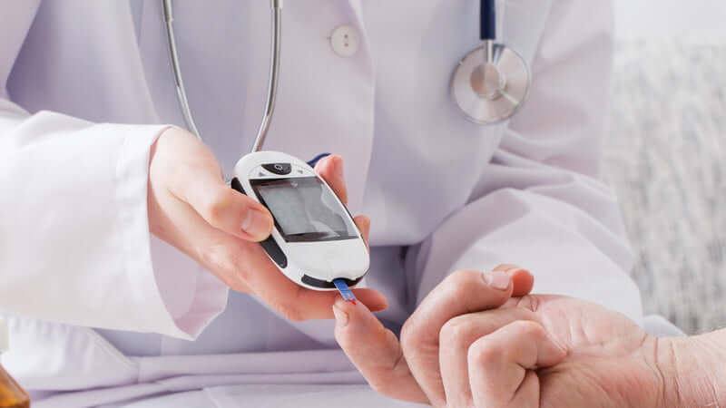 Doctor checking blood sugar levels to manage Magnesium and Diabetic Neuropathy.