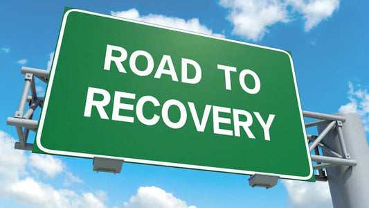 Sign reading 'Road to Recovery' symbolizing hope and healing for those seeking Chronic Pain Solutions.