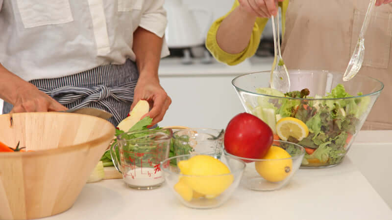 Human Nutrition Evolutionary Perspective, Preparing fresh ingredients for a salad, highlighting concepts in Human Nutrition: Evolutionary Perspective.