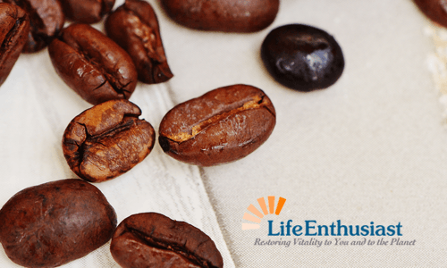 Coffee Break with freshly roasted coffee beans scattered on a cloth background.