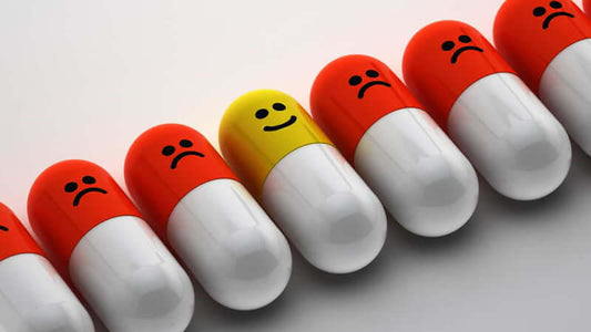 Colorful capsules featuring happy and sad faces, representing the Functions of Vitamins and their impact on health.