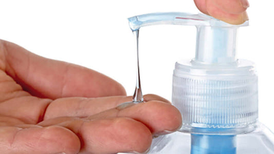 Hand dispensing antibacterial soap from a pump bottle, showcasing the product related to Antibacterial Soaps and Triclosan.
