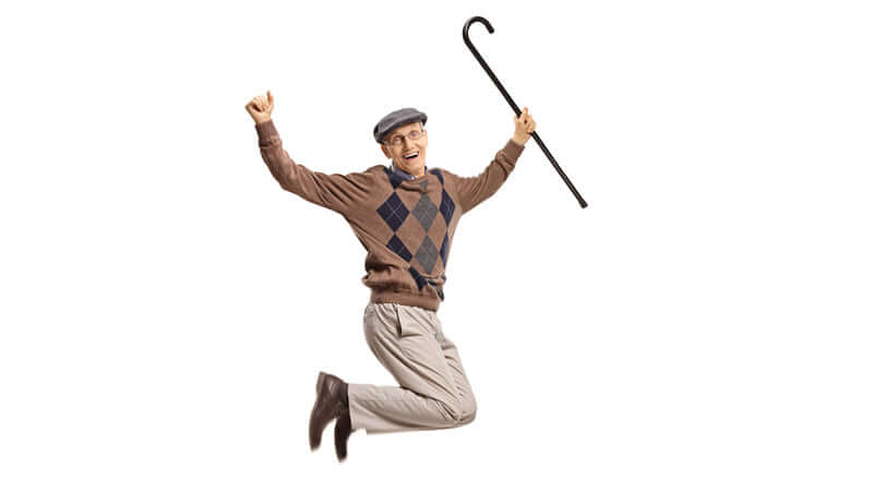 An elderly man jumping joyfully, showcasing the benefits of rebounding for fitness and happiness.