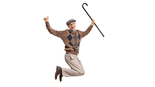 An elderly man jumping joyfully, showcasing the benefits of rebounding for fitness and happiness.
