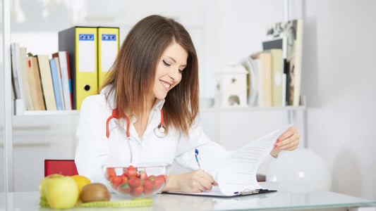 Woman with stethoscope reviewing notes on Politically Incorrect Nutritional Research at a desk.