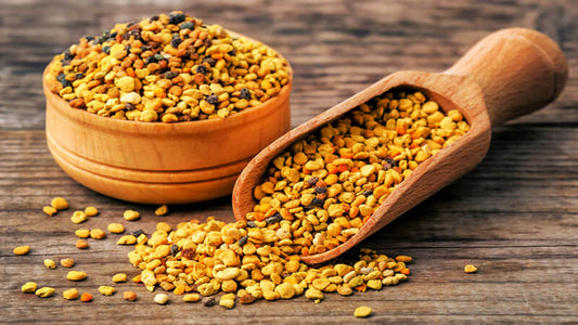 Bee Pollen as a Superfood in a wooden bowl and scoop on a rustic table.