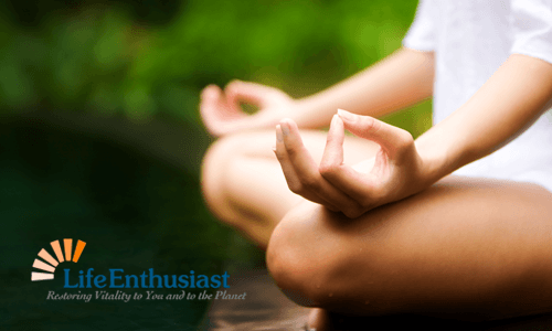 Person meditating by the water, focusing on inner peace and tranquility through Meditation.