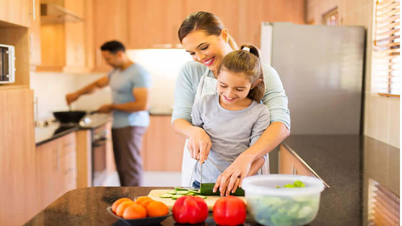 Mother and daughter preparing healthy meals in the kitchen, emphasizing a Holistic Approach To Health.