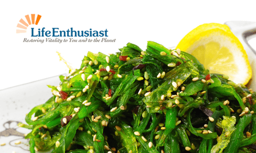 Fresh seaweed salad garnished with sesame seeds and lemon slices, showcasing nutritious seaweed.