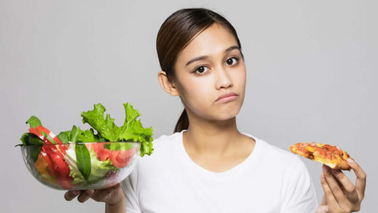 Woman pondering choices between salad and pizza while promoting Eating Wisely.