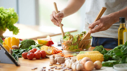 Preparing a fresh salad with various vegetables for a healthy lifestyle in the context of First Cleanse Then Nourish.