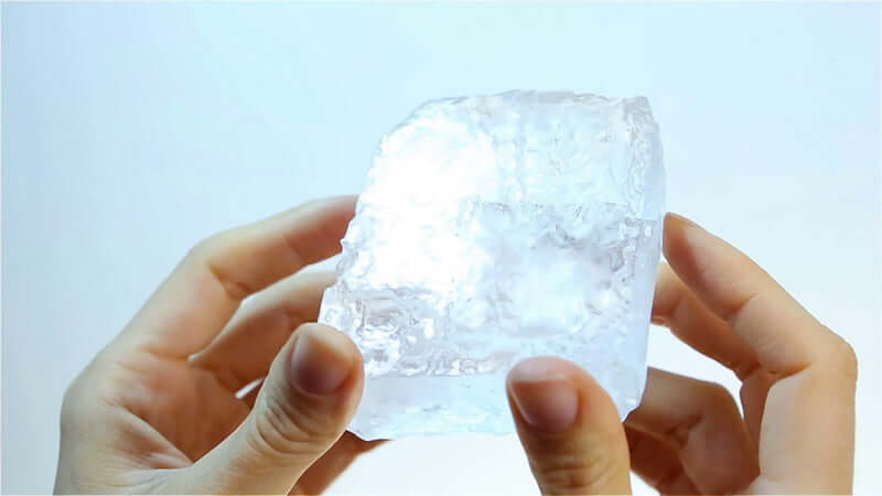 Person holding a piece of Himalayan Crystal Salt is THE Best in clear light.