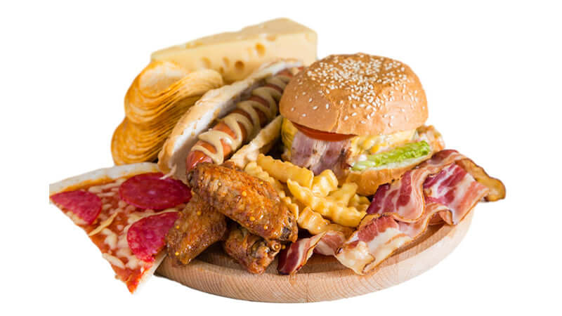 Trans Fatty Acids in Foods - unhealthy meal with burger, pizza, fries, and bacon