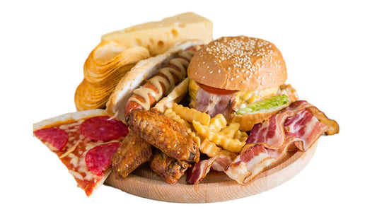 Trans Fatty Acids in Foods - unhealthy meal with burger, pizza, fries, and bacon