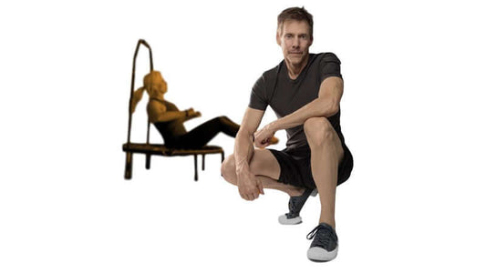 A man demonstrating Cellercising is Different from Rebounding workout techniques with a woman on a mini-trampoline.