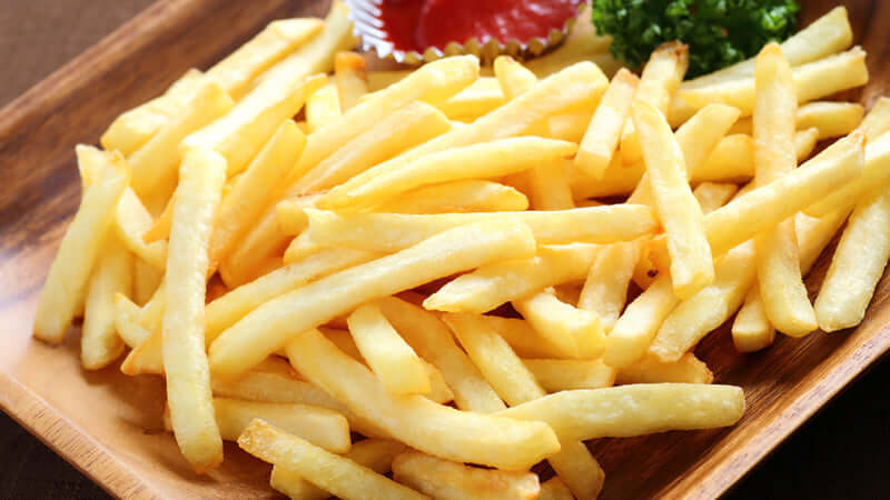 Movie Super Size Me by Megan Lehmann - a close-up of crispy golden French fries served with ketchup.