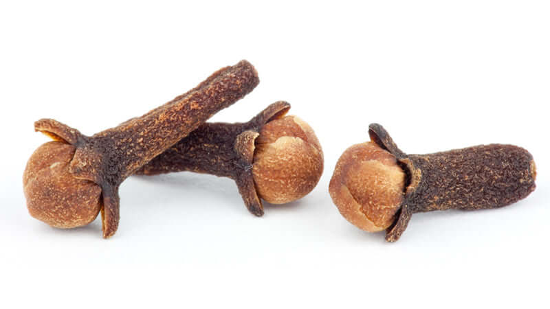 Close-up of whole Cloves, showcasing their distinctive brown color and shape, ideal for culinary purposes.