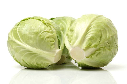 Three fresh green cabbages on a white background, showcasing their crispy leaves and round shape.