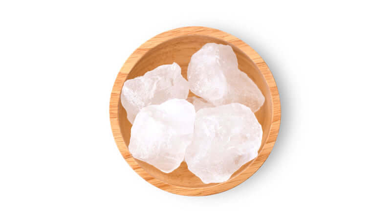 Minerals and Trace Elements in Crystal Salt in a wooden bowl with crystal salt pieces.