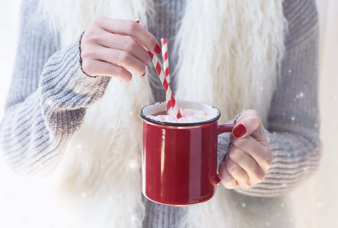 Another Aspartame Nightmare: a person stirring a drink in a red mug with a striped straw.