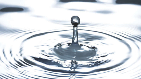 Exsula and Water droplet captured in a ripple effect showcasing fluid dynamics and nature's beauty.