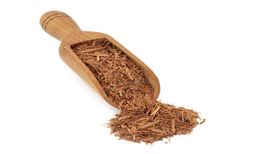 Catuaba bark shavings in a wooden scoop, showcasing natural herbal ingredients for supplements.