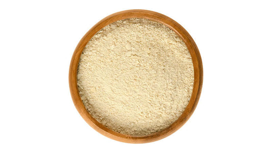 Bowl of Nutritional Yeast powder, a popular ingredient for adding flavor and nutrients to various dishes.