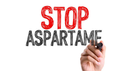 Hand writing 'STOP ASPARTAME' promoting awareness about health risks linked to Aspartame History of a Killer.