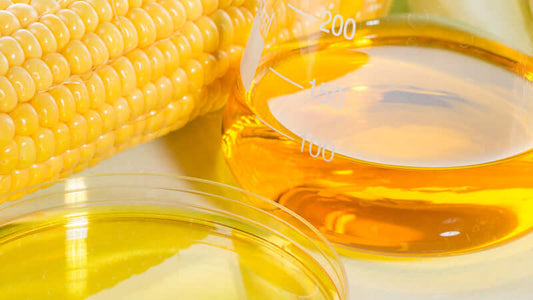 High Fructose Corn Syrup extracted from corn, shown in beakers and petri dish.