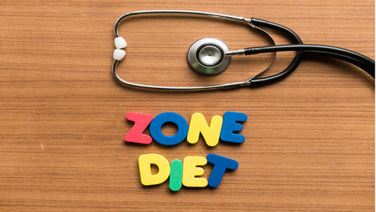 Colorful letters spelling 'ZONE DIET' next to a stethoscope on a wooden surface.
