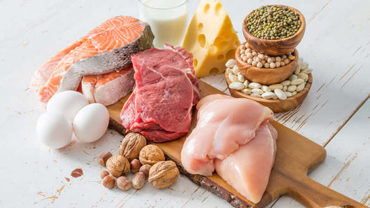 Raw Truth on Consuming Raw Meat and Dairy: fresh meat, dairy, and eggs on wooden board.