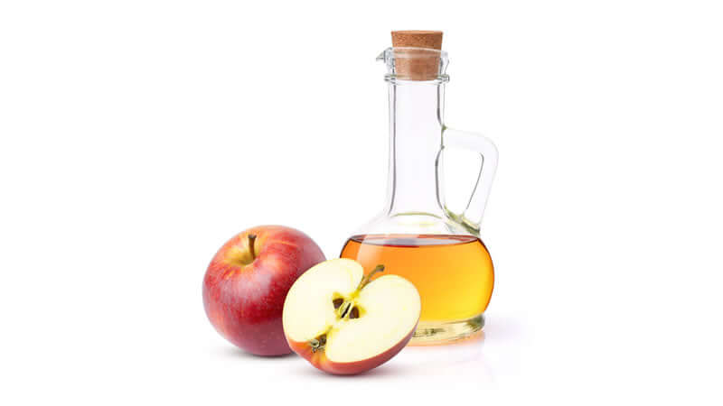 Potassium in Apple Cider Vinegar showcased with a bottle of vinegar and fresh apples.
