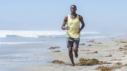 E3Live Algae Reviews athlete jogging on the beach, showcasing the benefits of E3Live Algae for athletic performance.