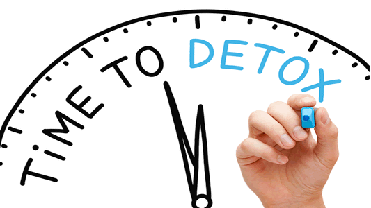 A hand writing 'Time to Detox' on a clock, emphasizing the importance of cleansing and detoxification.