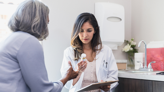 Doctor explaining policosanol side effects to a senior patient during consultation visit