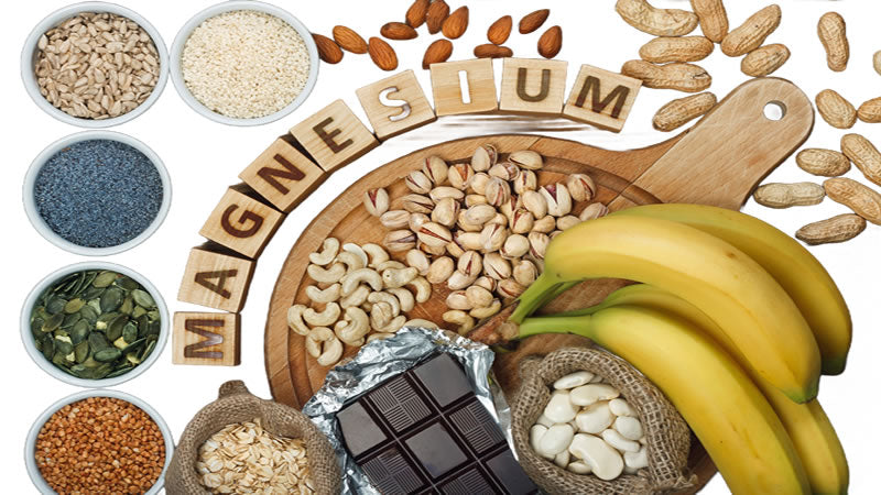 Assorted foods rich in magnesium, including nuts, seeds, bananas, and chocolate, highlighting magnesium for health.