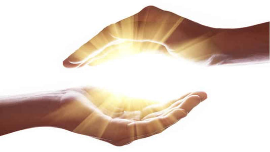 Two hands creating a protective barrier with a glowing light, symbolizing Magnesium and Radiation Protection.