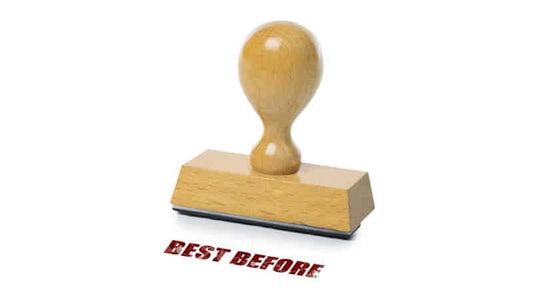 Wooden stamp reading 'BEST BEFORE' illustrating supplement expiry dates.