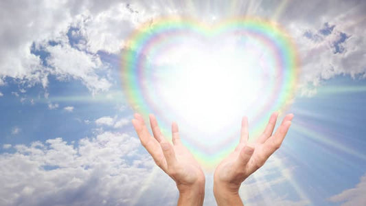 Hands holding radiant heart-shaped light symbolizing Tachyon Healing and the Physics of Love.