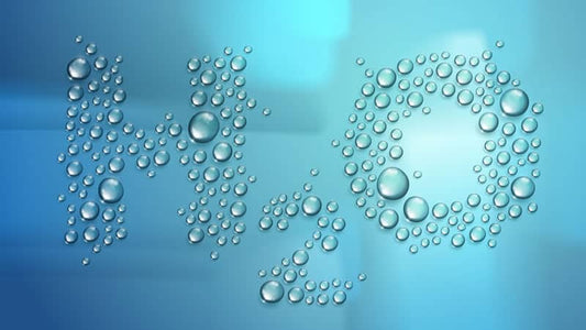 Water droplets forming the chemical formula for water, H2O, on a blue background, illustrating the concept of purity.